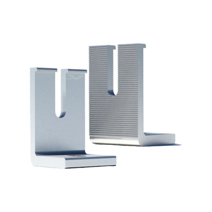 Crafted from durable aluminum, the IronRidge LFT-03-M1 Slotted L-Foot stands upright with one foot featuring a smooth texture and the other displaying a ridged surface. With slots at the top, they are ideal for roof mounting or securing objects with precise rail height adjustments.