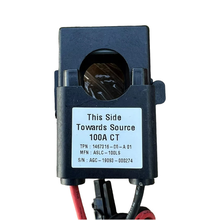 A black electrical component labeled "This Side Towards Source" with the Tesla brand and product name 100A CT, featuring serial and part numbers. It has two red wires and one black wire attached at the bottom.