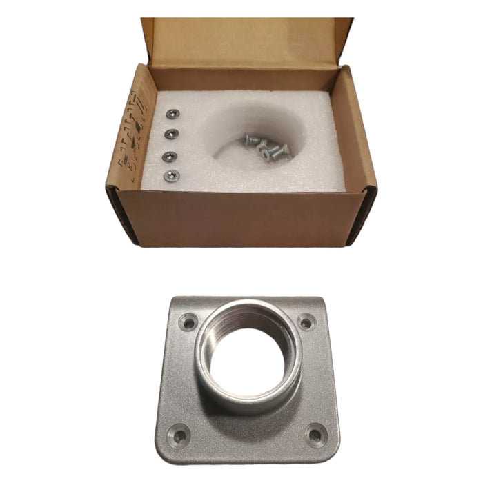 A Tesla Conduit Hub, featuring a metal mounting plate with a central hole, is placed on a surface. Behind it, an open cardboard box from Tesla contains foam padding and several screws. These items seem to be components of a hardware or mounting assembly kit.