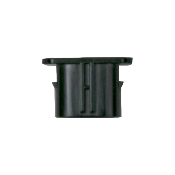 The Solartek NEP BQ End Cap for Female Connector is a black plastic piece with rectangular and cylindrical shapes, a slightly flared top edge, and a central vertical groove, all set against a plain white background.