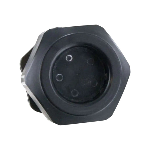 Close-up of a black, hexagonal object with a circular center featuring four small holes. The beveled edges and watertight seal suggest a mechanical or industrial component, akin to the Heyco M3234GBR-SM 3/4" Cordgrip 5 Hole. The background is plain white.